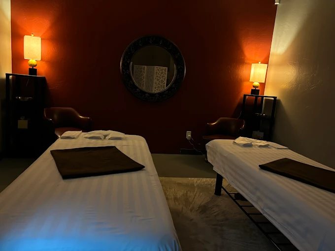 The Desert Zen couples suite: two massage tables side by side under warm lamplight