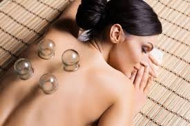 Glass cups resting on a guest's back during a cupping session